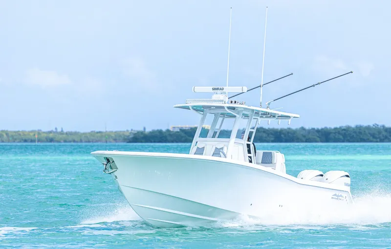 Slide: The Image of 2024 Invincible 33 Open Fisherman boat cruising on clear blue water. - 5