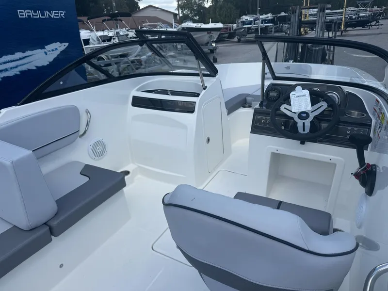 Slide: The Image of 2025 Bayliner VR4 Bowrider OB interior with modern seating and steering console. - 6