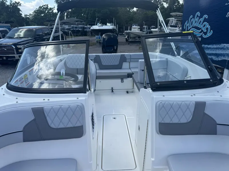 Slide: The Image of 2025 Bayliner VR4 Bowrider OB with spacious seating and modern design in a marina setting. - 7