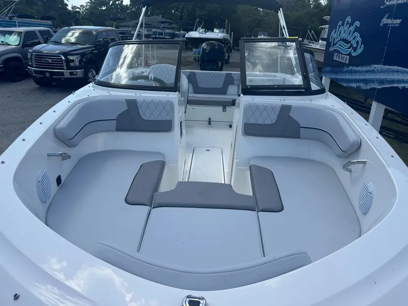 Slide: The Image of 2025 Bayliner VR4 Bowrider OB with spacious seating and modern design in a marina setting. - 8