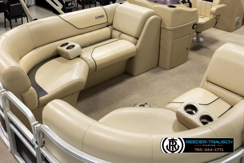 Slide: The Image of 2016 Lowe SS230 pontoon boat interior with beige seating and cup holders. - 10
