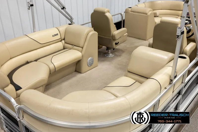Slide: The Image of 2016 Lowe SS230 pontoon boat with beige seating and spacious interior. - 12