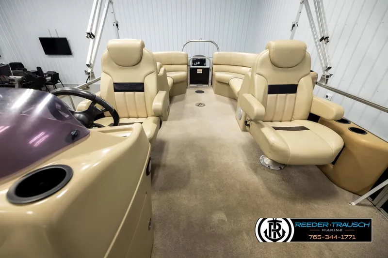 Slide: The Image of Interior of a 2016 Lowe SS230 pontoon boat with beige seating and steering console. - 14