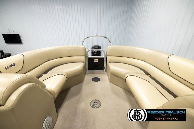 Slide: The Image of 2016 Lowe SS230 boat interior with beige seating and steering console. - 15
