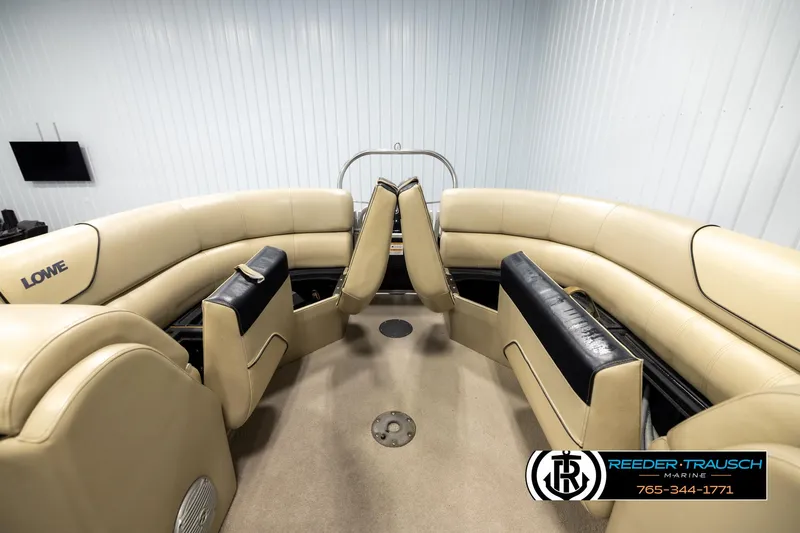 Slide: The Image of 2016 Lowe SS230 boat interior with beige seating and black accents. - 16