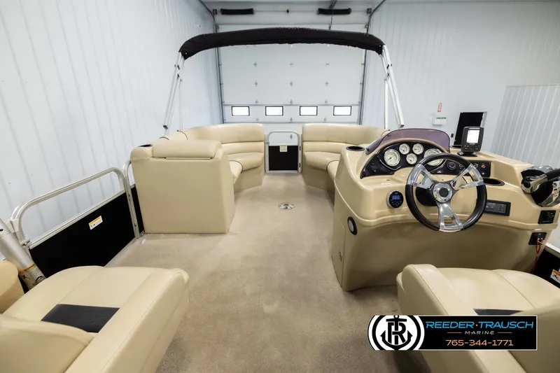 Slide: The Image of 2016 Lowe SS230 pontoon boat interior with beige seating and steering console. - 19