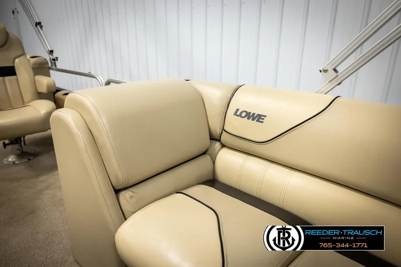 Slide: The Image of 2016 Lowe SS230 boat interior with beige seating and logo. - 23