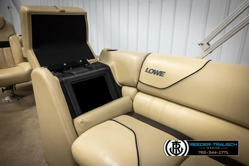 Slide: The Image of 2016 Lowe SS230 boat interior with beige seating and storage compartment. - 24