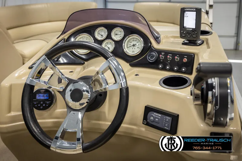 Slide: The Image of Steering console of a 2016 Lowe SS230 boat with gauges and controls. - 25