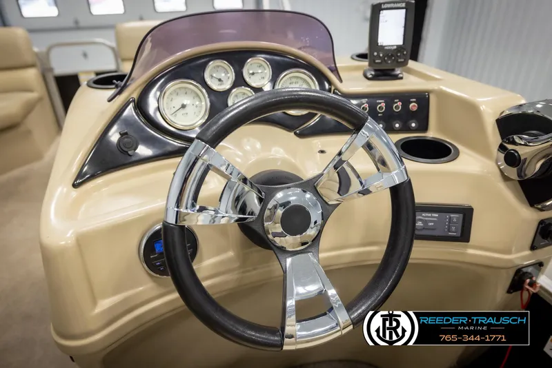 Slide: The Image of Steering wheel and dashboard of 2016 Lowe SS230 boat with gauges and controls. - 26