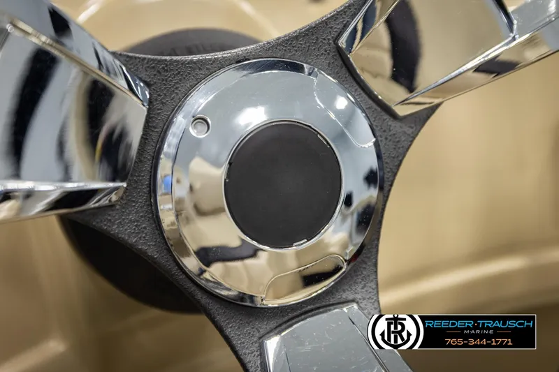 Slide: The Image of Close-up of a 2016 Lowe SS230 steering wheel with chrome details. - 27