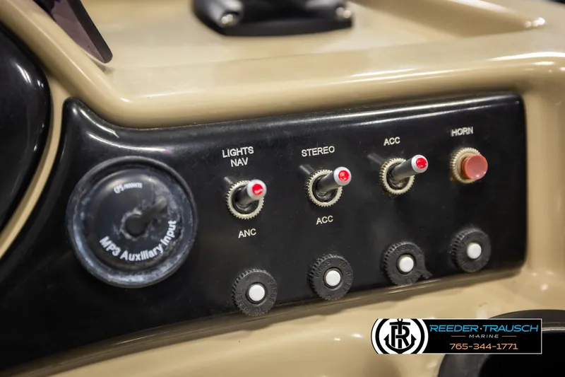 Slide: The Image of Control panel of a 2016 Lowe SS230 boat with switches and MP3 auxiliary input. - 31