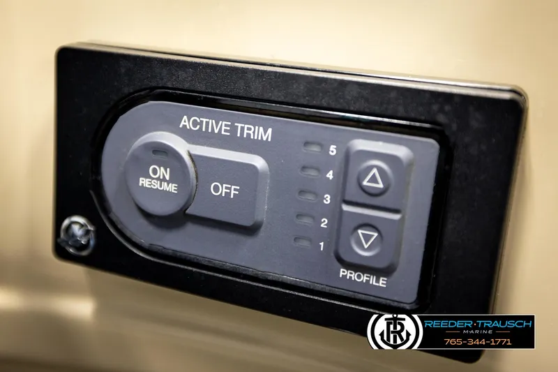 Slide: The Image of Active trim control panel on a 2016 Lowe SS230 boat dashboard. - 32