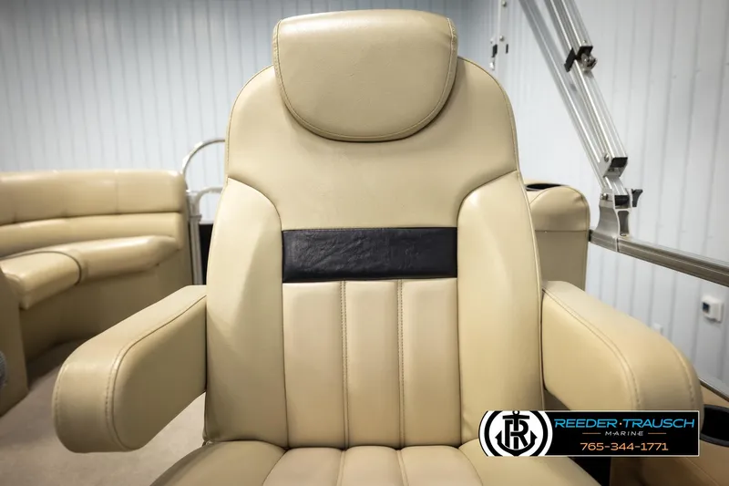 Slide: The Image of Beige captain's chair in 2016 Lowe SS230 boat, featuring plush upholstery and armrests. - 34