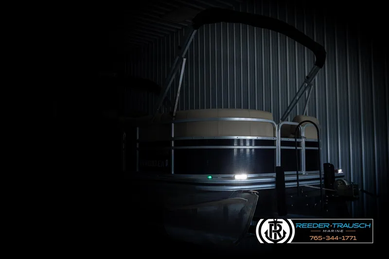 Slide: The Image of 2016 Lowe SS230 pontoon boat in dimly lit storage facility. - 4