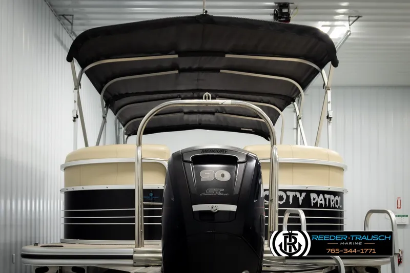 Slide: The Image of 2016 Lowe SS230 pontoon boat with canopy and 90 HP engine in a storage facility. - 7
