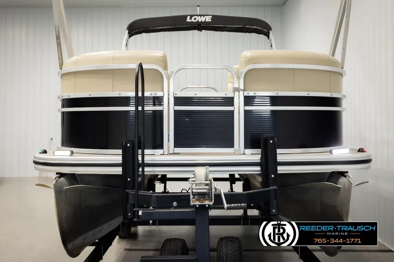 Slide: The Image of 2016 Lowe SS230 pontoon boat on trailer in indoor storage facility. - 8