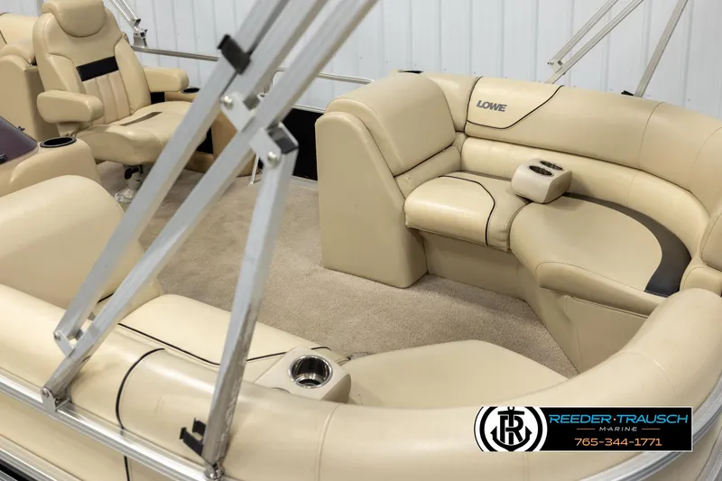 Slide: The Image of 2016 Lowe SS230 pontoon boat interior with beige seating and carpet. - 9