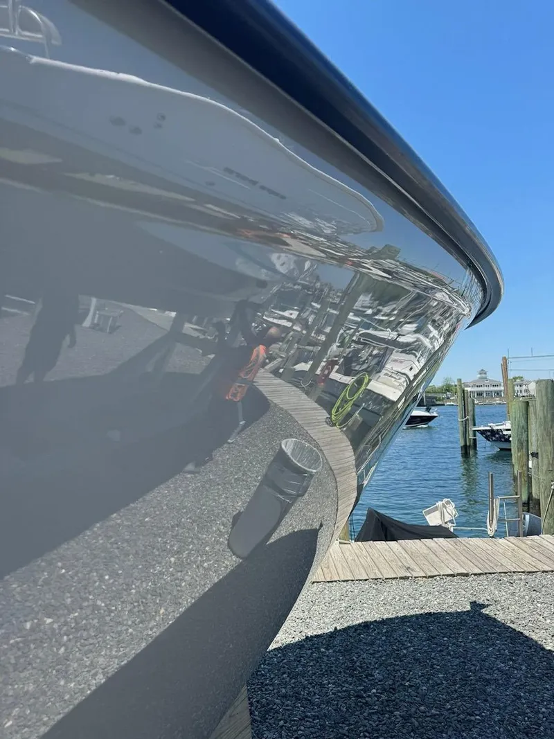 Slide: The Image of 2022 Cape Horn 27 XS boat with T-top and rod holders under clear blue sky. - 12