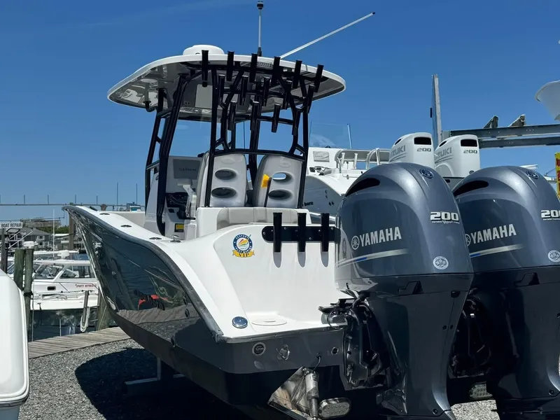 The Image of 2022 Cape Horn 27 XS boat with dual Yamaha 200 engines, docked under clear blue sky. - 0
