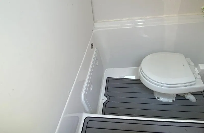 Slide: The Image of 2022 Cape Horn 27 XS boat reflecting marina scene, clear blue sky. - 10