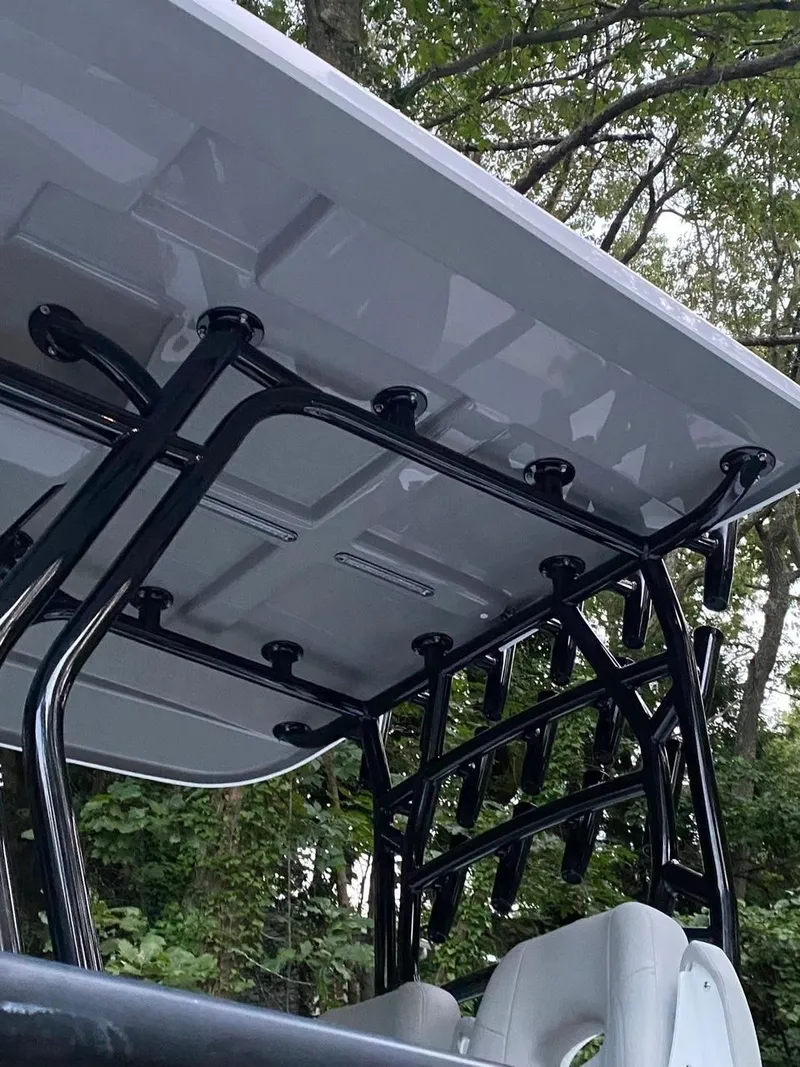 Slide: The Image of Rod holders on a 2022 Cape Horn 27 XS boat, with lush greenery in the background. - 18