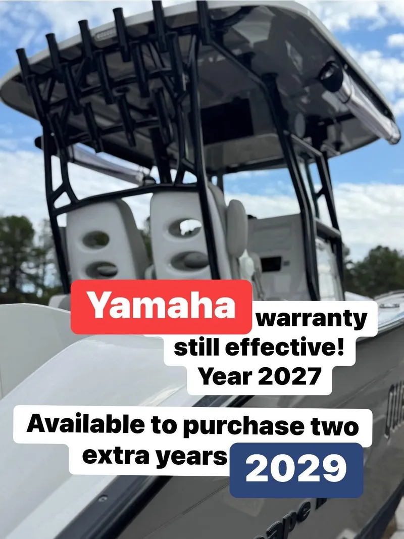 Slide: The Image of 2022 Cape Horn 27 XS boat, docked with overcast sky and trees in the background. - 4