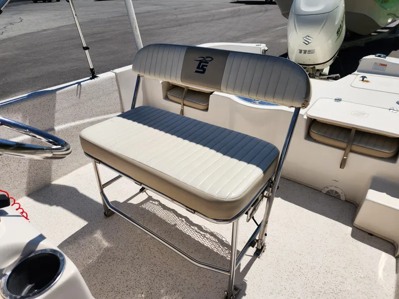 Slide: The Image of 2018 Carolina Skiff 218 DLV boat seat with steering wheel and Suzuki outboard motor. - 11