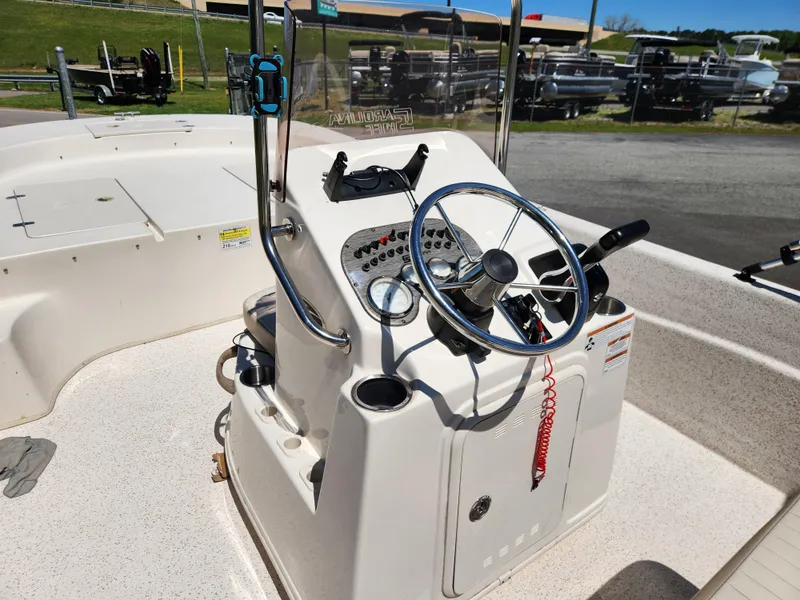 Slide: The Image of 2018 Carolina Skiff 218 DLV boat console with steering wheel and controls. - 12