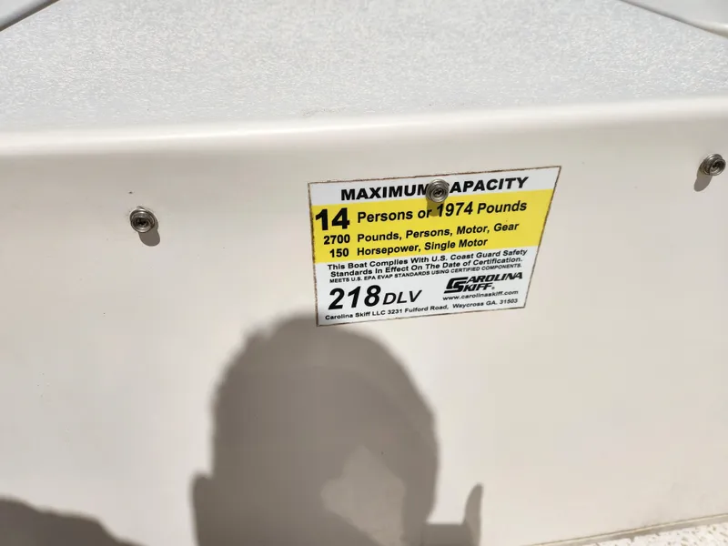 Slide: The Image of 2018 Carolina Skiff 218 DLV capacity label: 14 persons, 1974 pounds, 150 horsepower. - 13