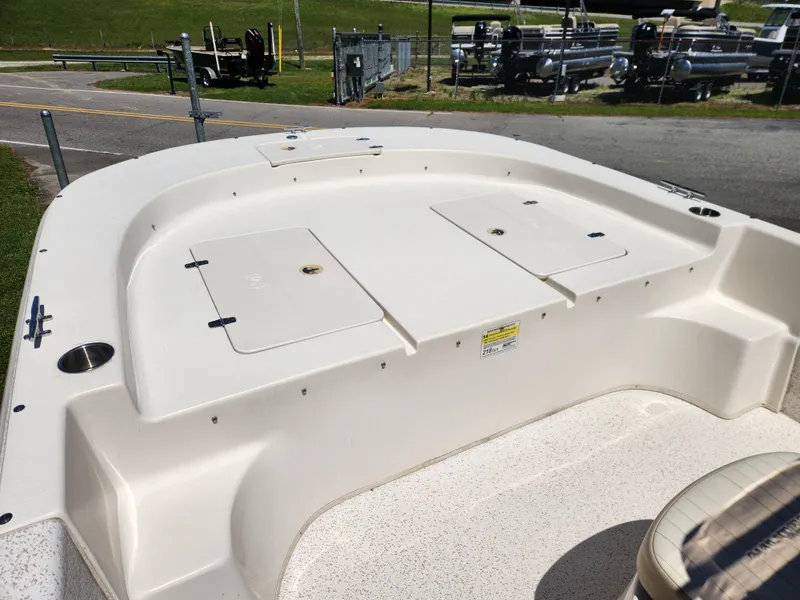 Slide: The Image of 2018 Carolina Skiff 218 DLV boat deck with storage compartments and seating area. - 8