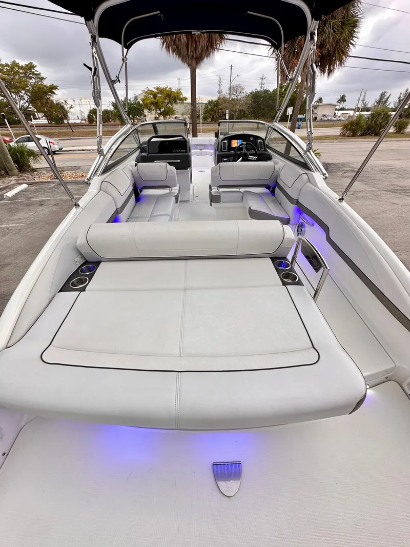 Slide: The Image of 2021 Formula 270 Bowrider with spacious seating and ambient lighting, parked outdoors. - 21