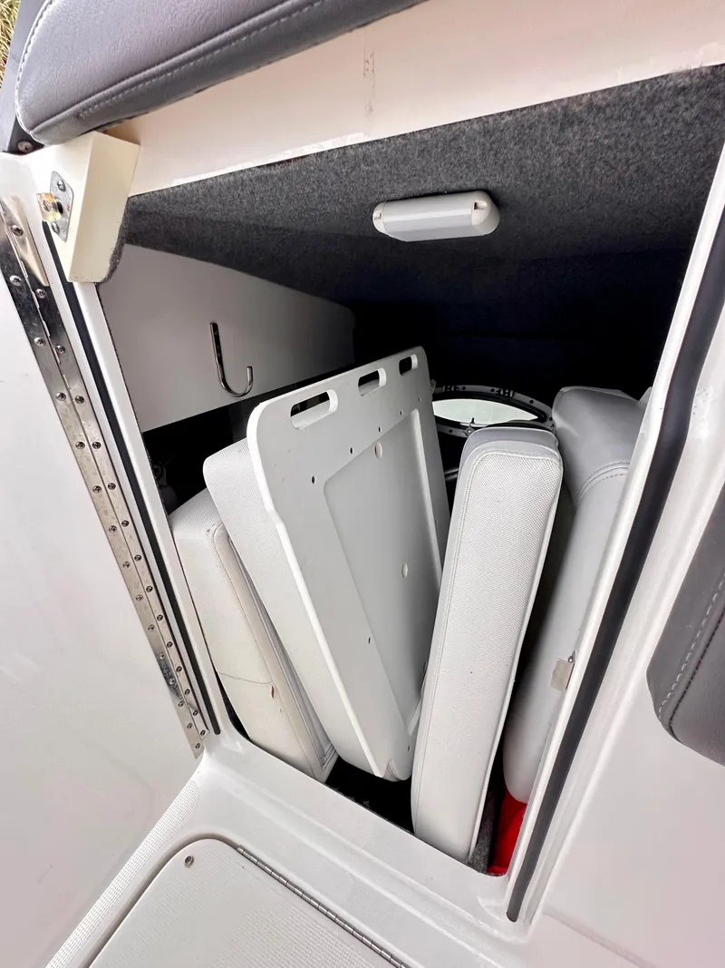 Slide: The Image of 2021 Formula 270 Bowrider storage compartment with neatly stacked cushions. - 23