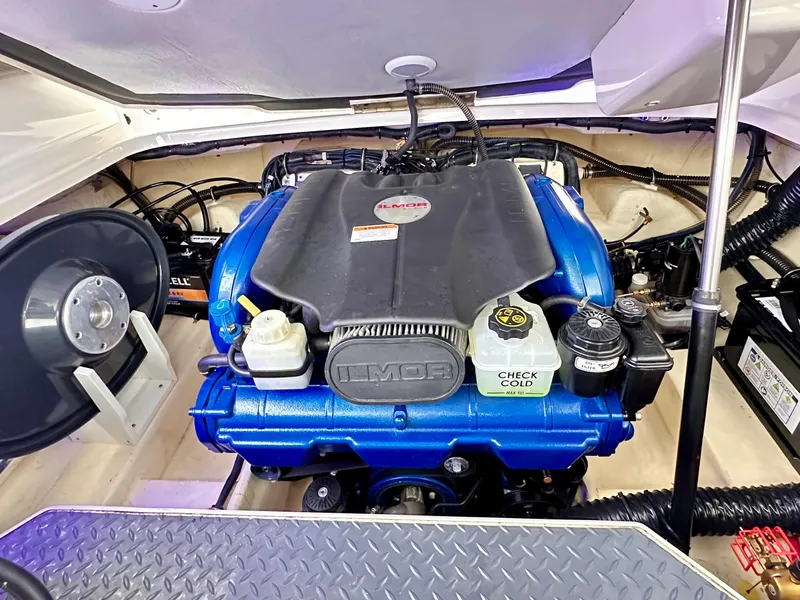 Slide: The Image of Engine compartment of a 2021 Formula 270 Bowrider boat, featuring a blue engine. - 24