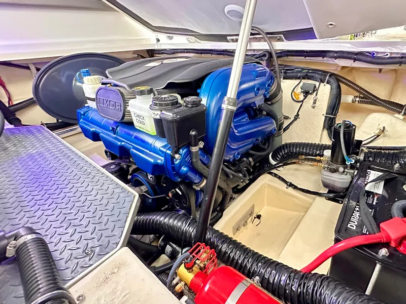 Slide: The Image of Engine compartment of a 2021 Formula 270 Bowrider, featuring a blue MerCruiser engine. - 25