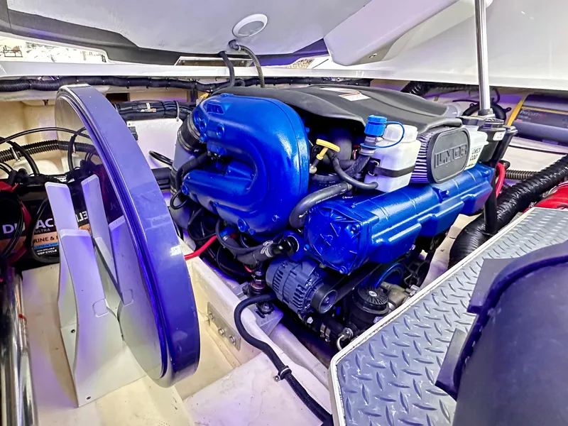Slide: The Image of Engine compartment of a 2021 Formula 270 Bowrider boat, showcasing a powerful blue engine. - 26