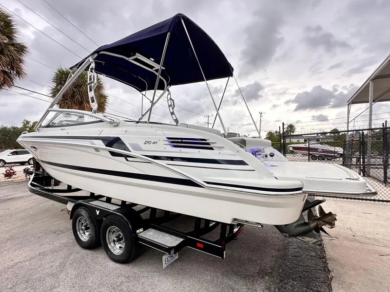 Slide: The Image of 2021 Formula 270 Bowrider boat on trailer with canopy, parked outdoors. - 5