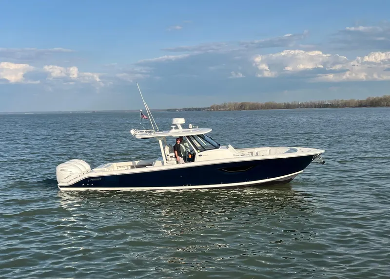 Slide: The Image of 2022 Pursuit S 378 Sport boat cruising on calm waters under a clear sky. - 10