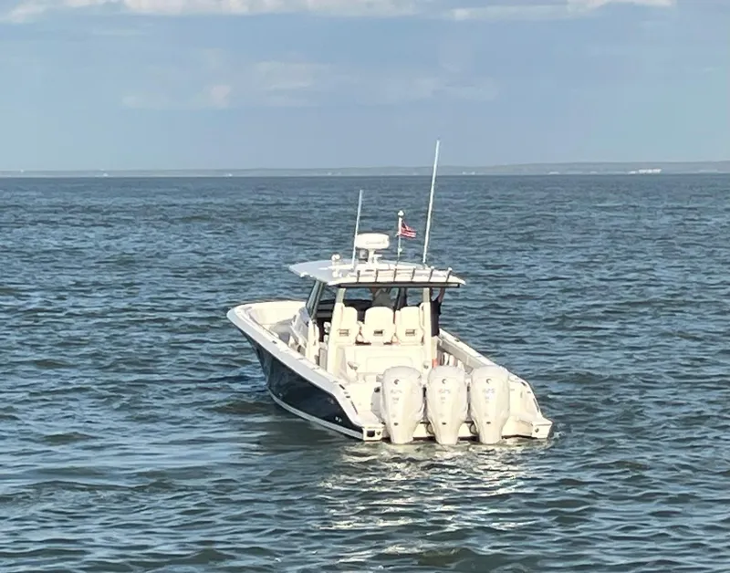 Slide: The Image of 2022 Pursuit S 378 Sport boat on open water with triple engines. - 13