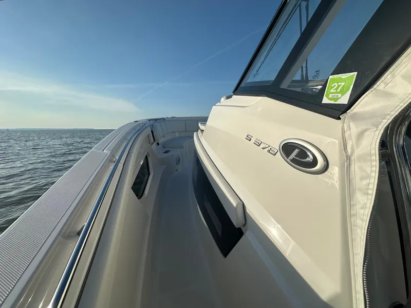 Slide: The Image of 2022 Pursuit S 378 Sport boat on open water, side view with clear sky. - 14