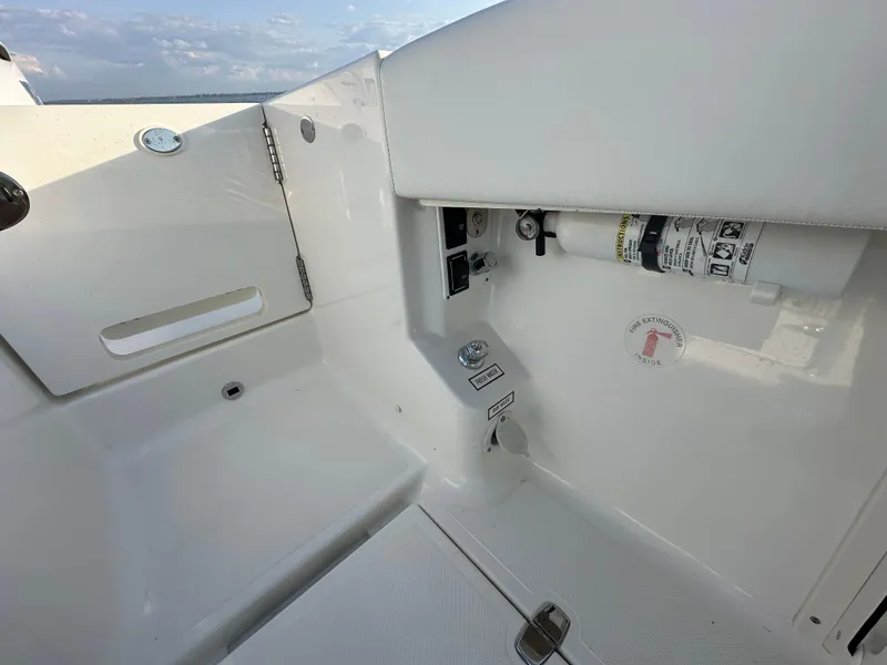 Slide: The Image of 2022 Pursuit S 378 Sport boat interior with safety equipment and storage compartment. - 28