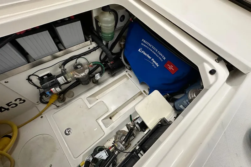 Slide: The Image of Engine compartment of 2022 Pursuit S 378 Sport boat, showcasing mechanical components and wiring. - 29