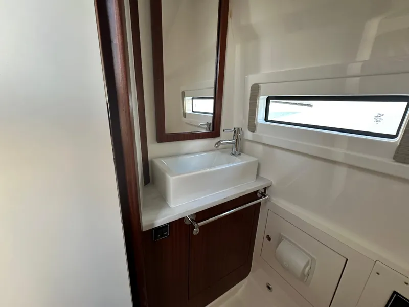 Slide: The Image of 2022 Pursuit S 378 Sport boat bathroom with modern sink and window. - 35