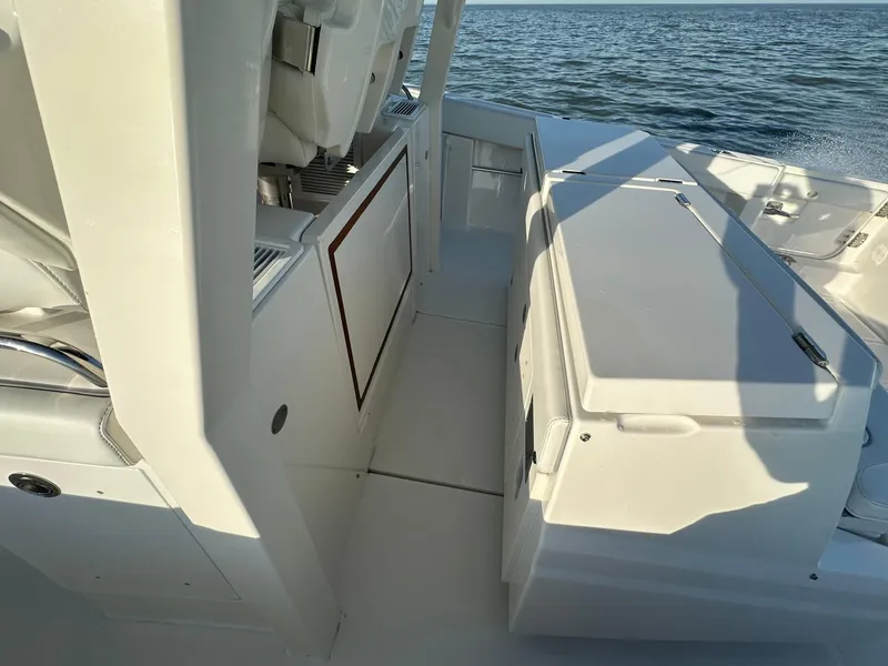 Slide: The Image of 2022 Pursuit S 378 Sport boat interior with seating and storage, overlooking the ocean. - 41