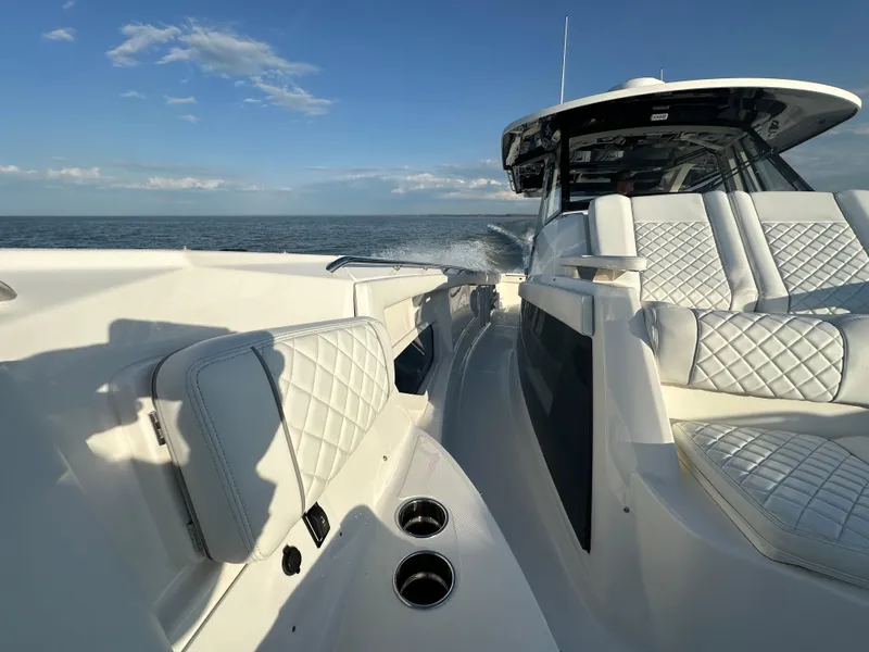 Slide: The Image of 2022 Pursuit S 378 Sport boat with luxurious seating on open water. - 42