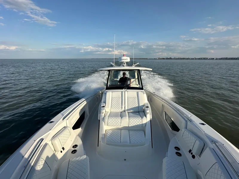 Slide: The Image of 2022 Pursuit S 378 Sport boat cruising on open water under clear skies. - 5