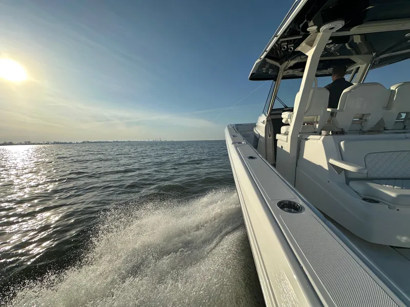 Slide: The Image of 2022 Pursuit S 378 Sport boat cruising on open water at sunset. - 6