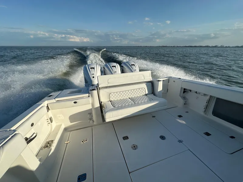 Slide: The Image of 2022 Pursuit S 378 Sport boat cruising on open water, showcasing powerful engines. - 7