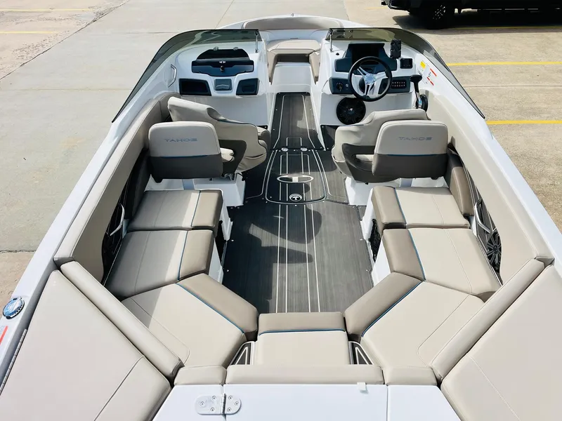 Slide: The Image of 2024 Tahoe 210 S Limited boat interior with spacious seating and modern dashboard. - 10