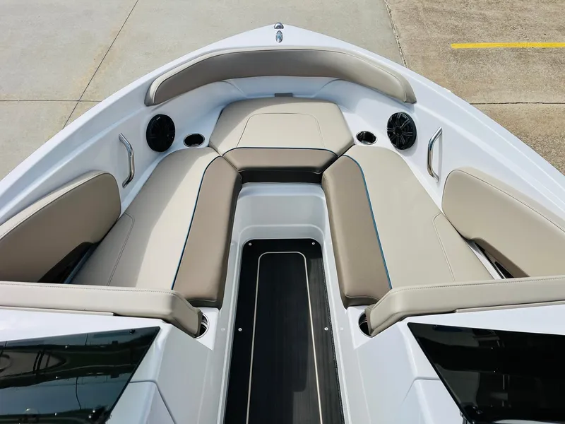Slide: The Image of 2024 Tahoe 210 S Limited boat interior with beige seating and black accents. - 11